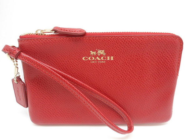 Red leather wristlet with Coach logo.