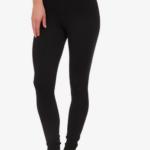 Woman wearing black leggings, standing barefoot.