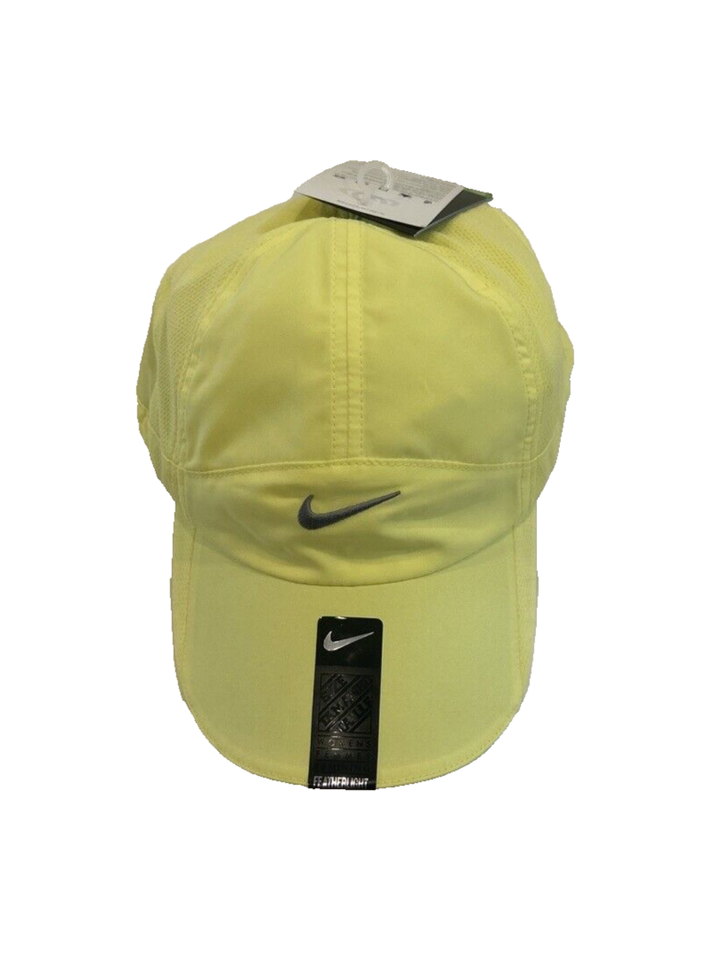 Yellow Nike cap with tag and logo.