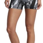 Person wearing camo shorts and white sneakers.