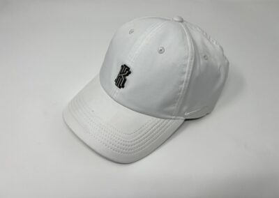 White Cap with black batch on display