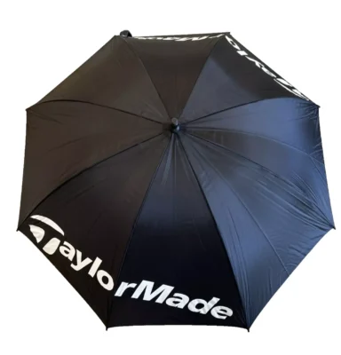Black TaylorMade umbrella with white logo.
