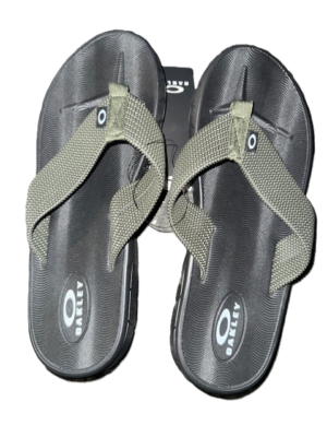 Gray flip-flops with green straps.