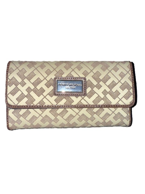 Patterned beige clutch with metal logo plate.