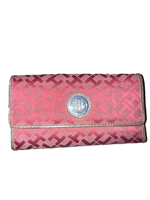 Red patterned wallet with circular emblem.