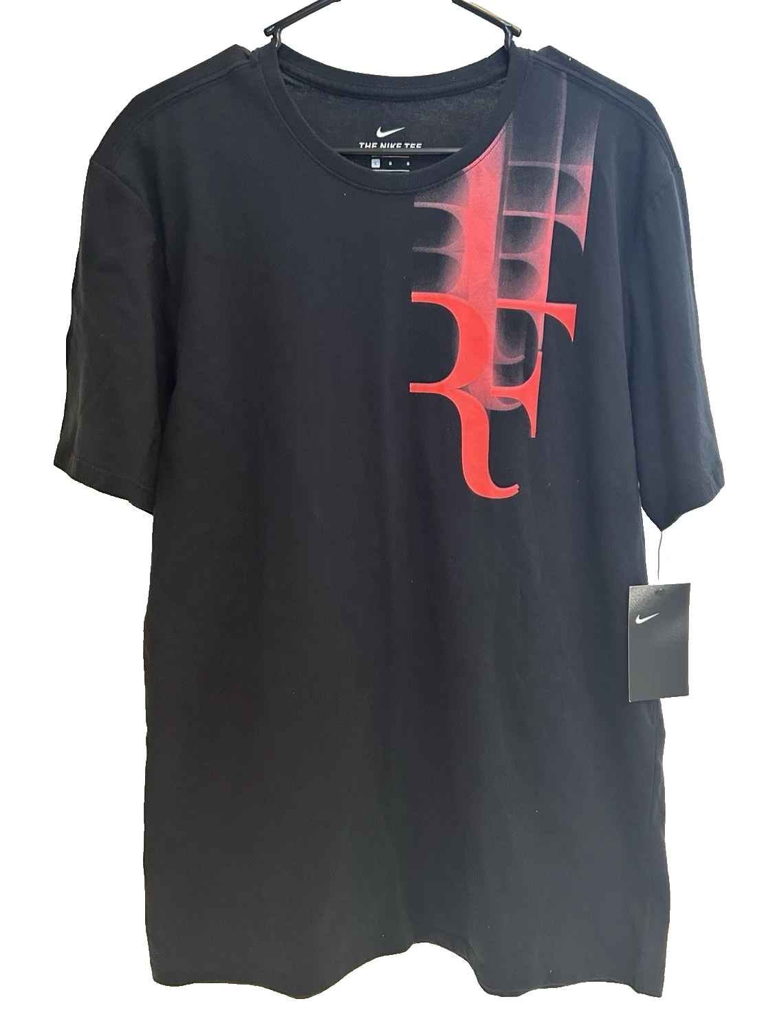 Black T-shirt with red abstract design.