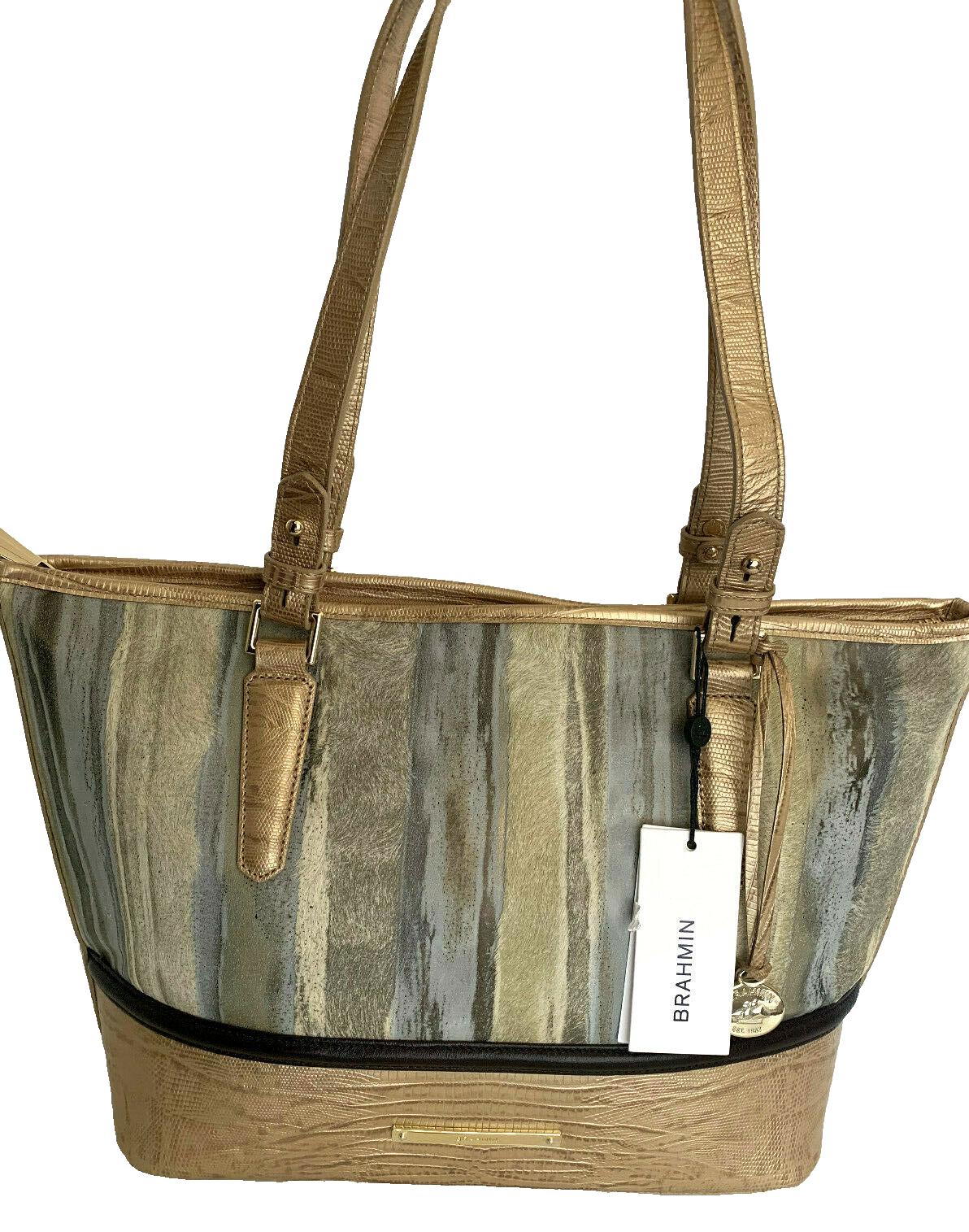Striped handbag with gold accents and straps.