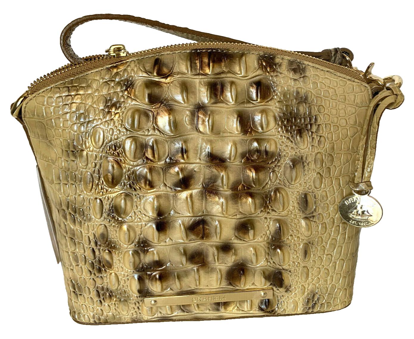 Gold textured handbag with embossed pattern.