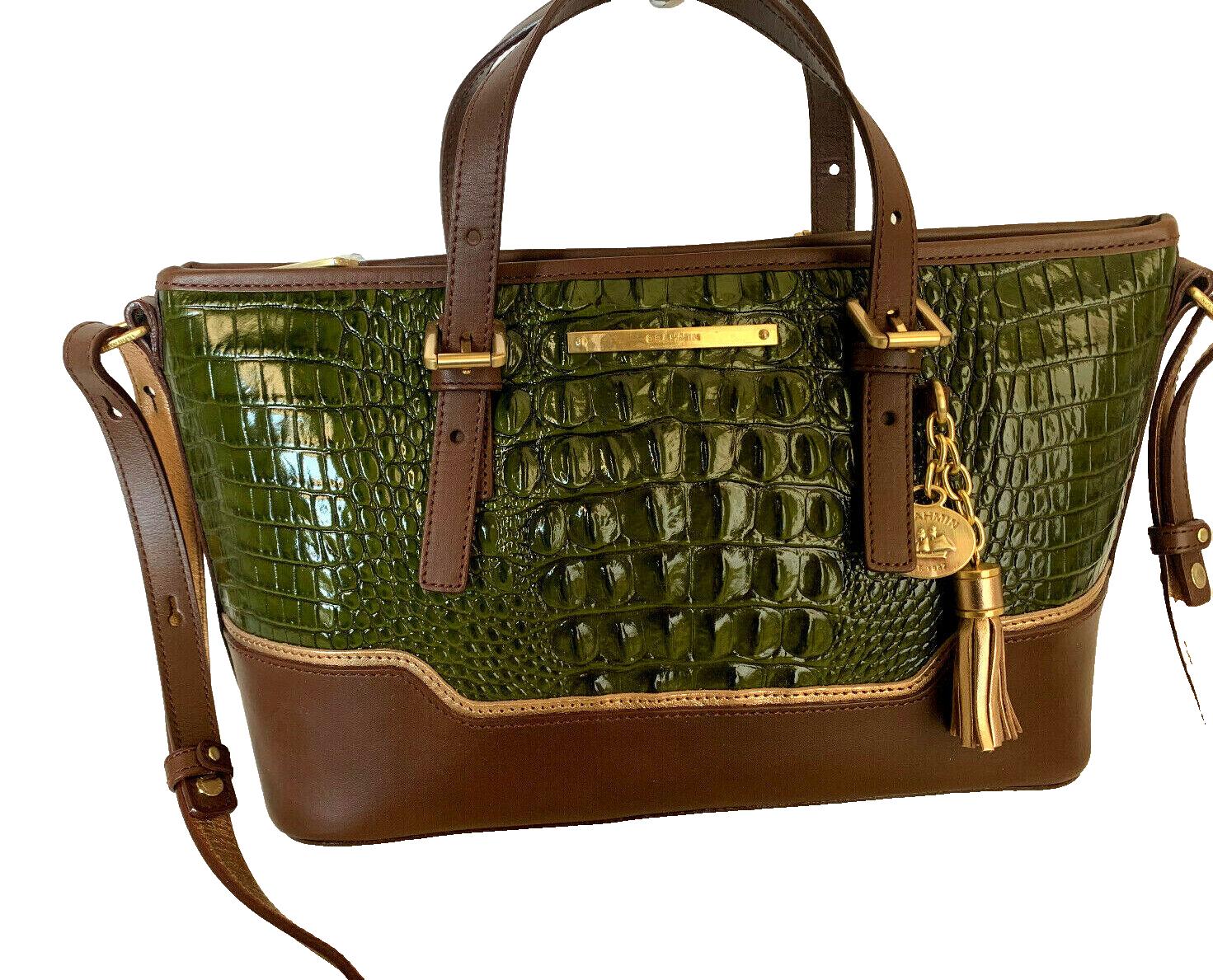 Green and brown leather handbag with tassel.