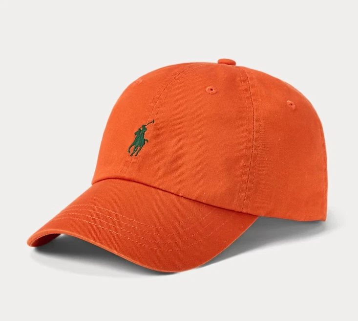Orange baseball cap with green embroidered logo.