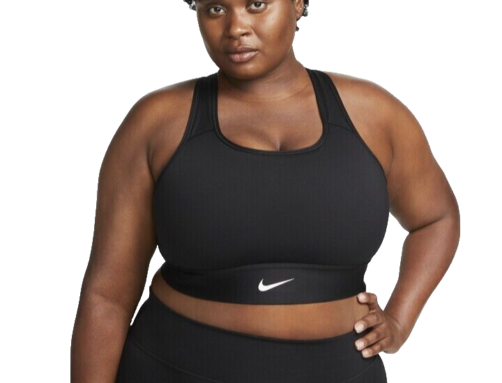 Person in black athletic wear posing confidently.